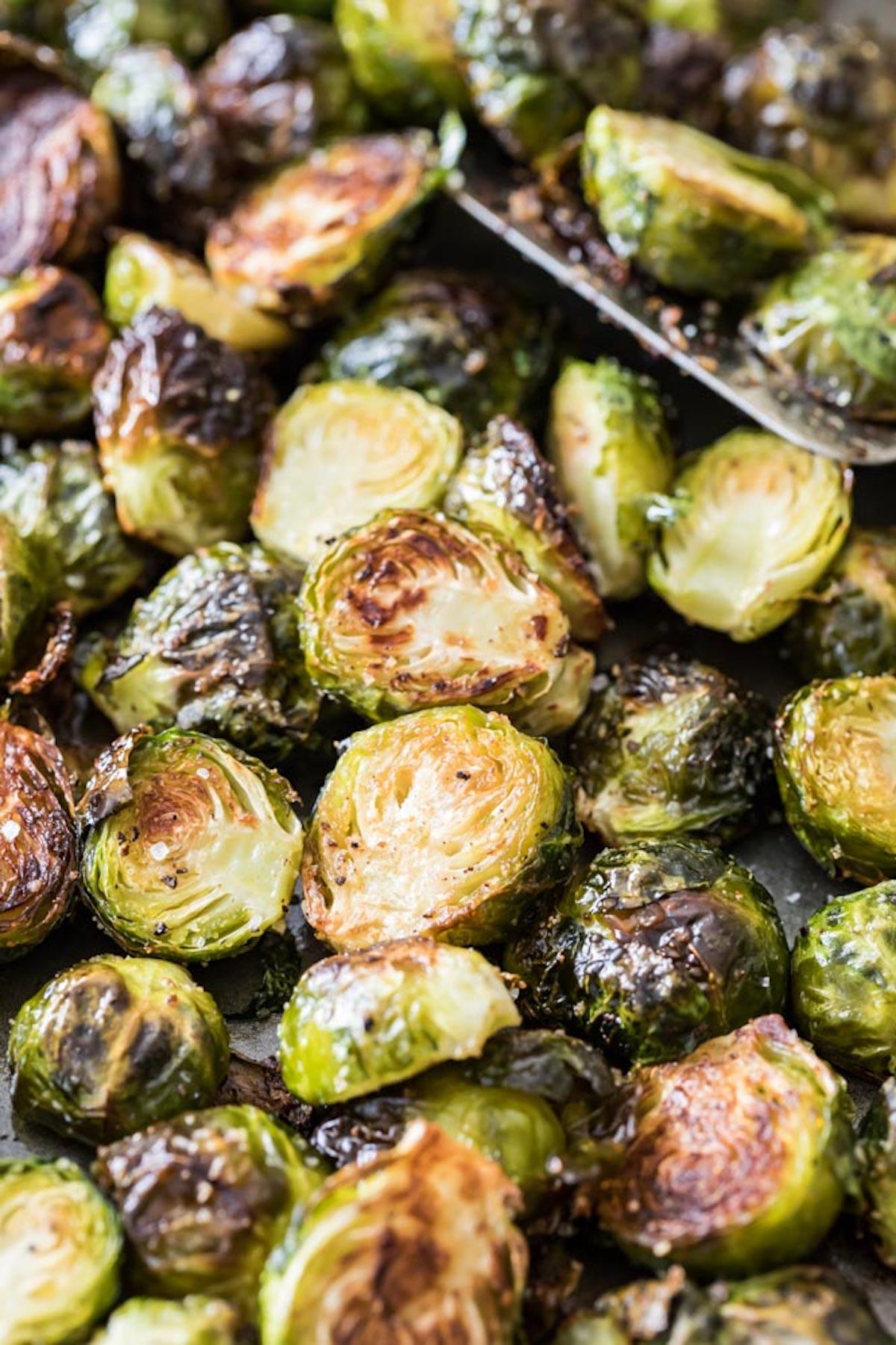 Close-up of perfectly roasted Brussels sprouts on a baking sheet