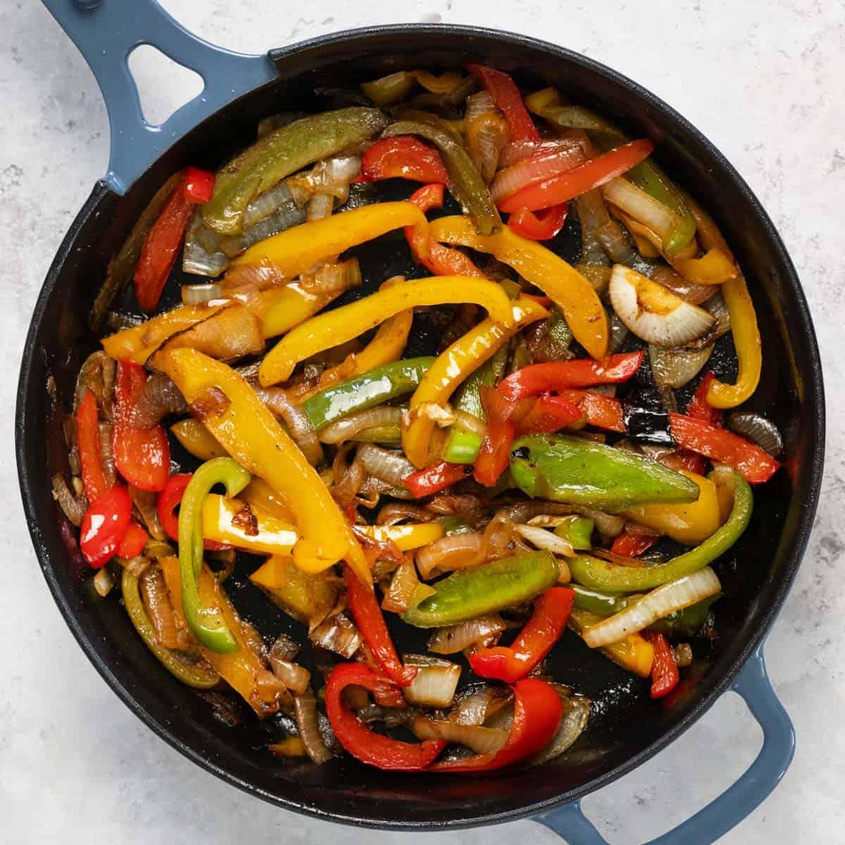 close up of sauteed bell peppers in a skillet with teriyaki glaze