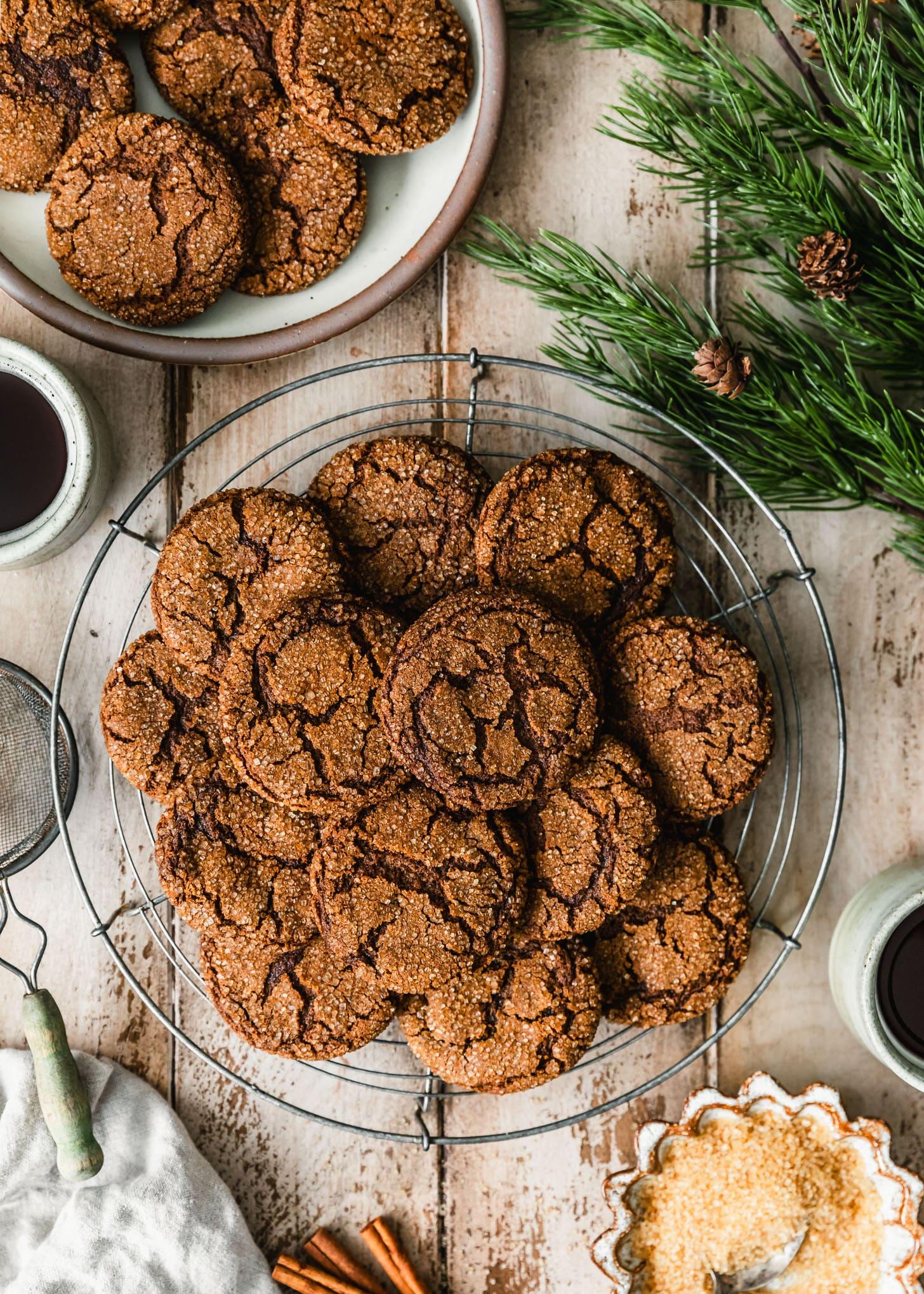 A family gathering around a table with a plate of ginger molasses cookies