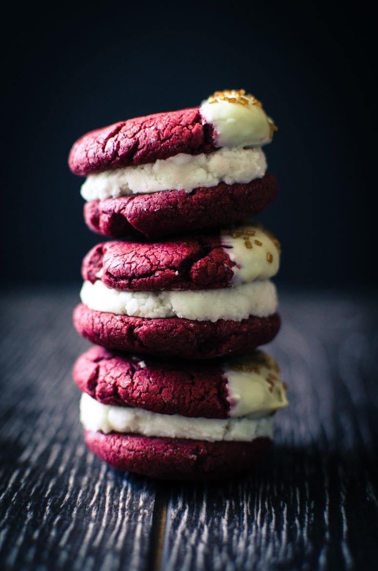 close-up of red velvet sliders with white chocolate chips stacked on a plate