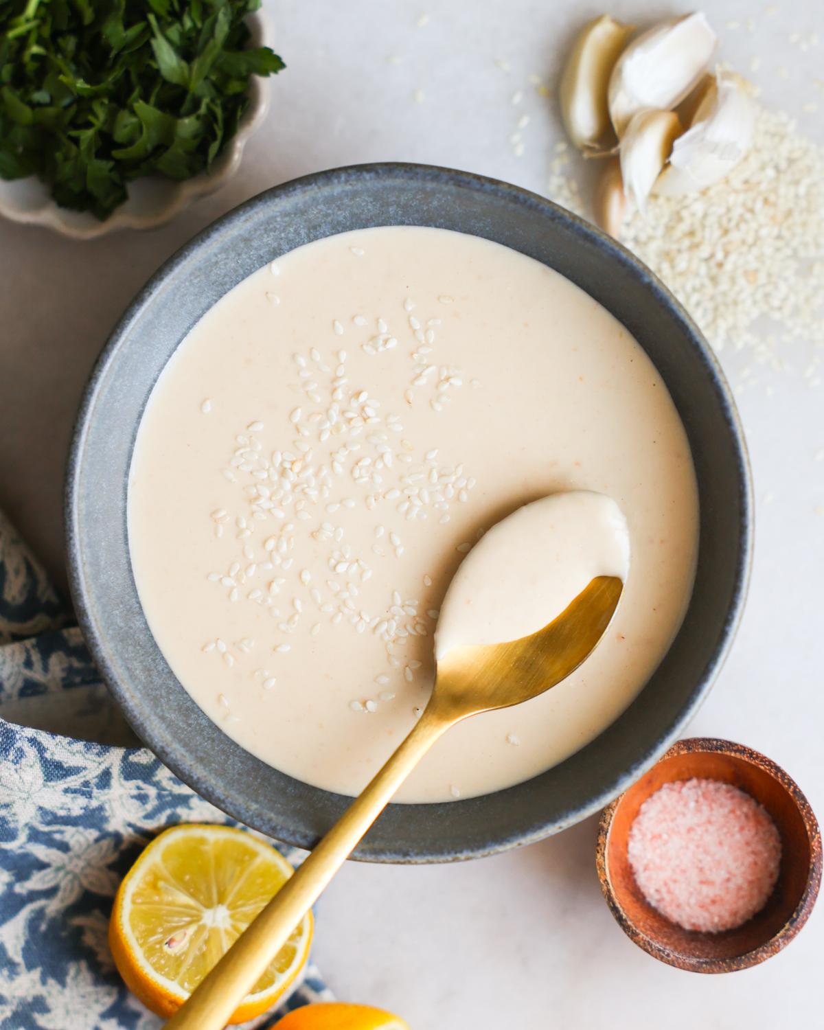 A small bowl of tahini dressing, highlighting its creamy texture