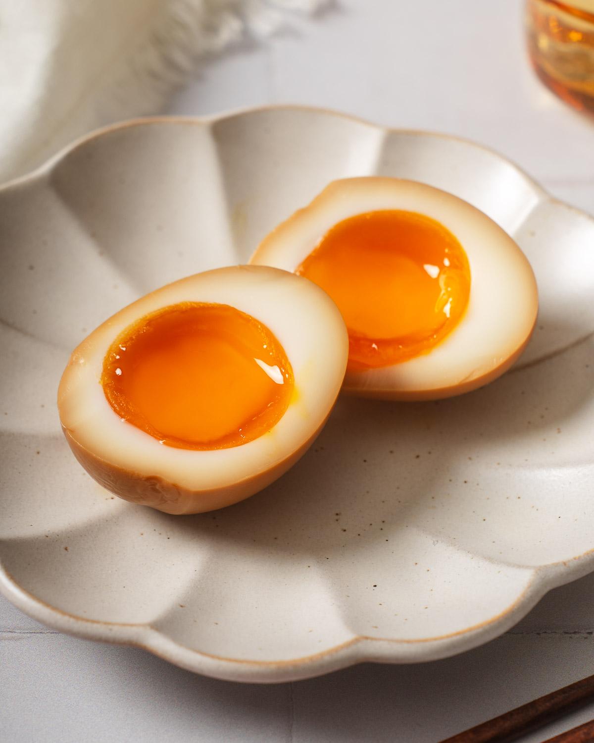 close-up of a soft-boiled egg (ajitama) in a bowl of ramen, highlighting the yolk and texture