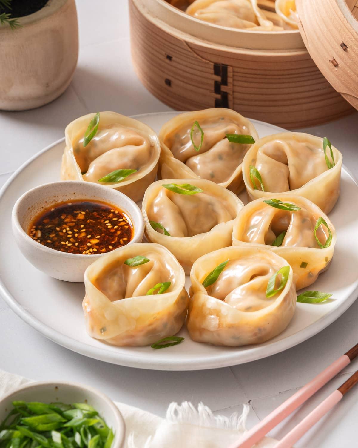 A steaming basket filled with perfectly formed kimchi and pork mandu