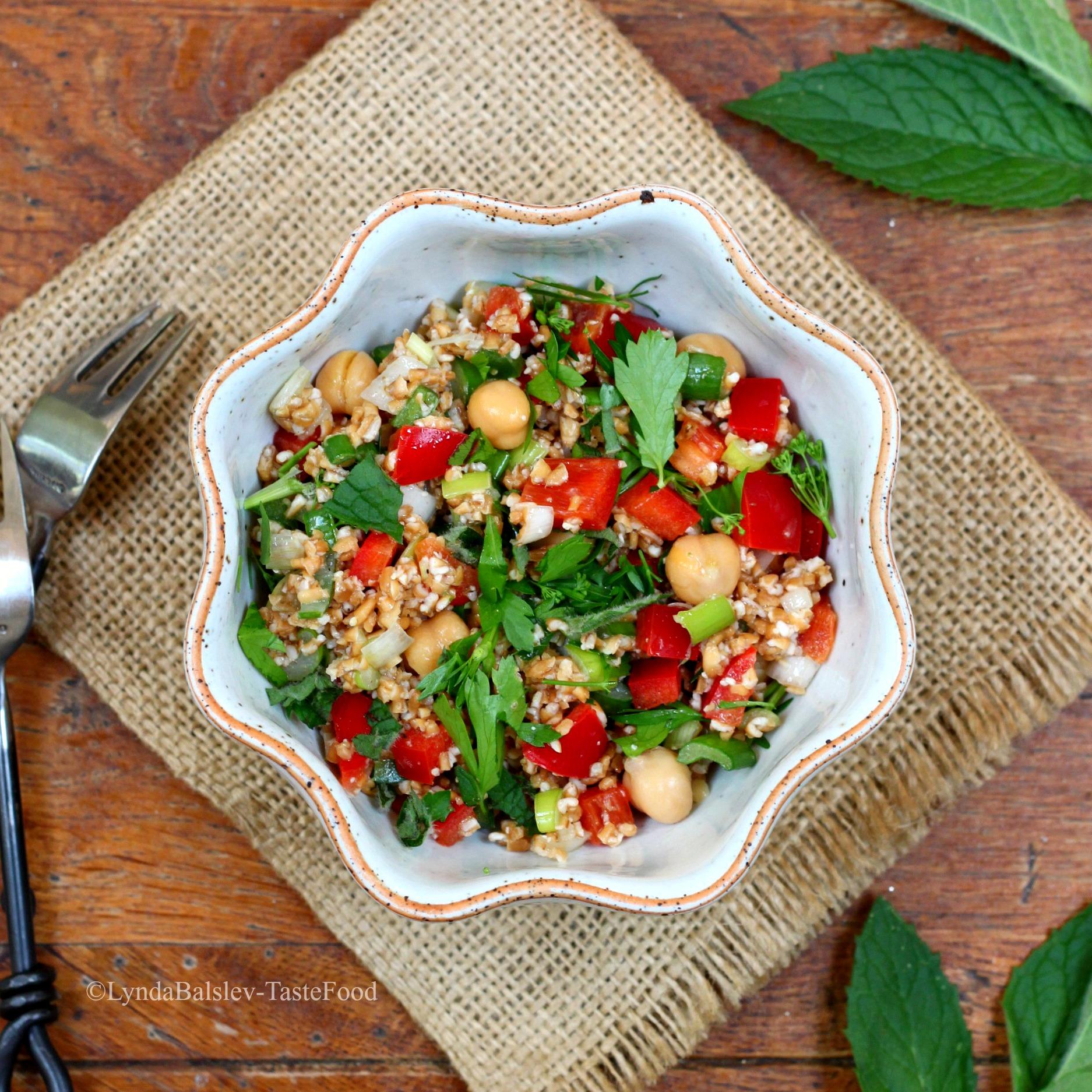 overhead shot of a bowl of greek tabbouleh salad on a rustic table
