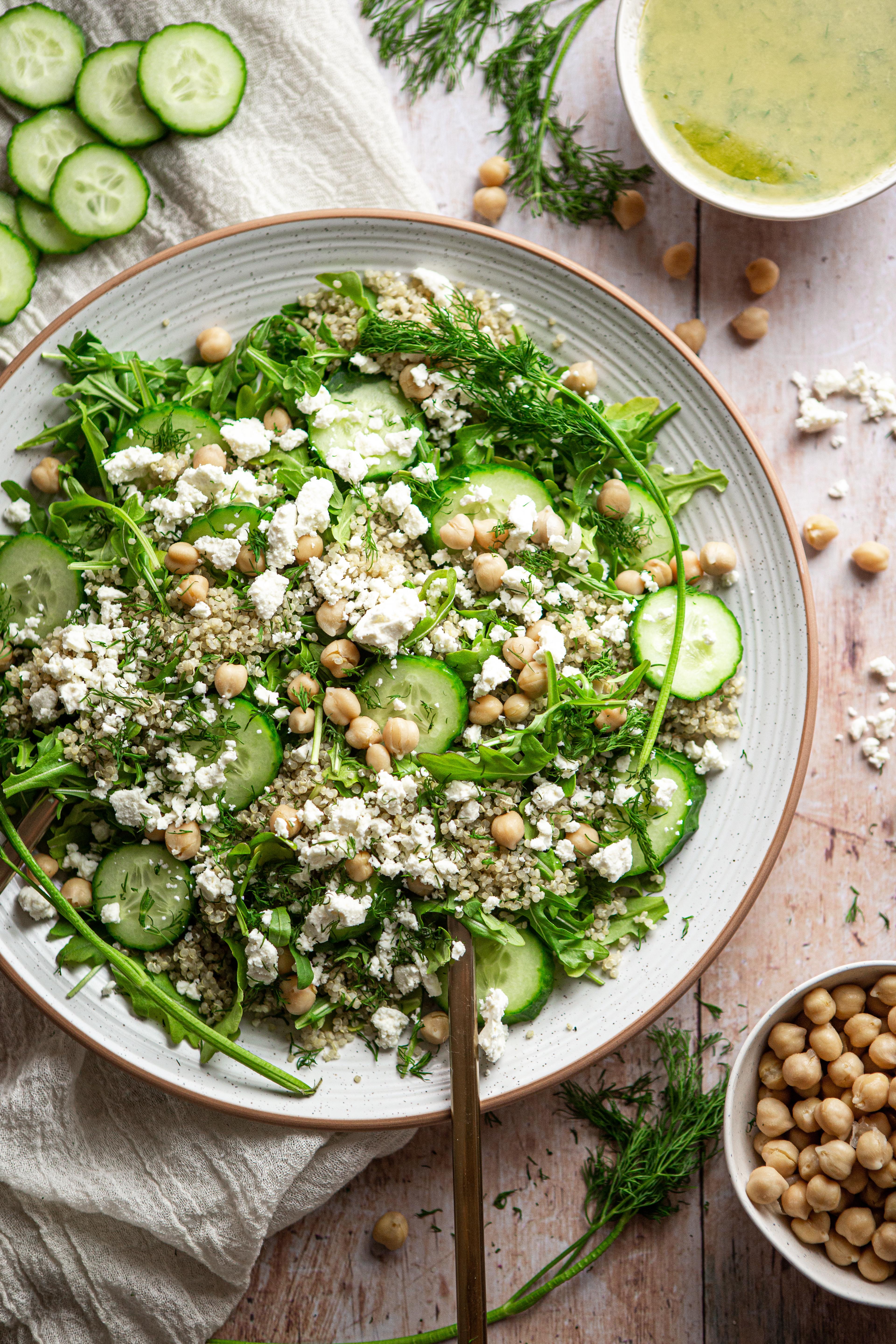 close-up shot of a bowl of creamy quinoa salad with dill and cucumber