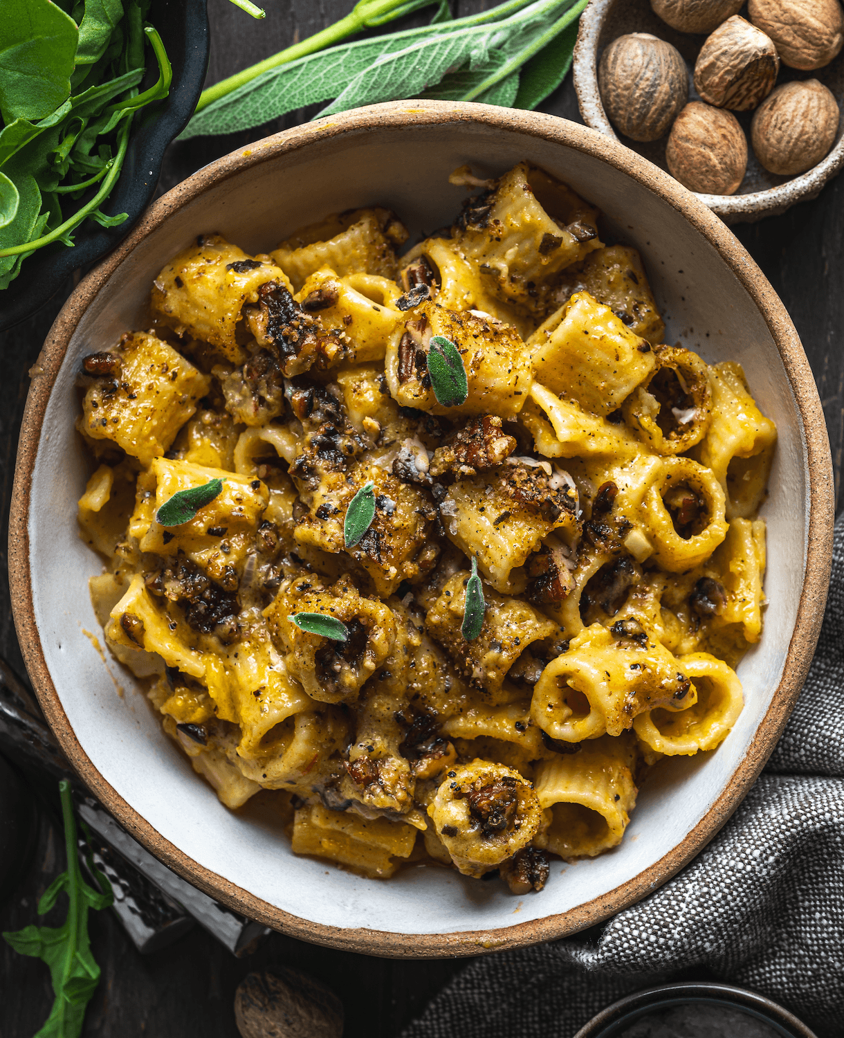 A bowl of creamy, cheesy mac and cheese with chunks of roasted butternut squash.