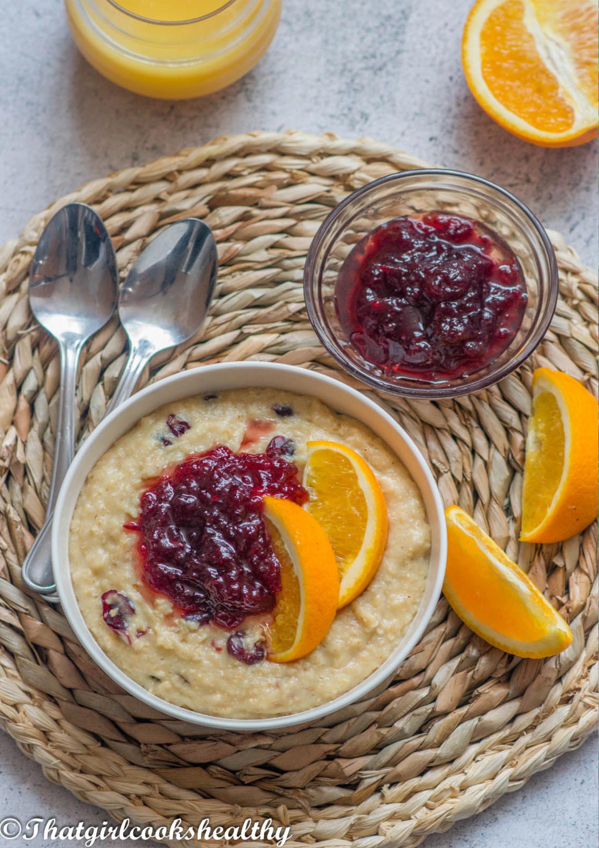 close up of a bowl of cranberry orange oatmeal with walnuts