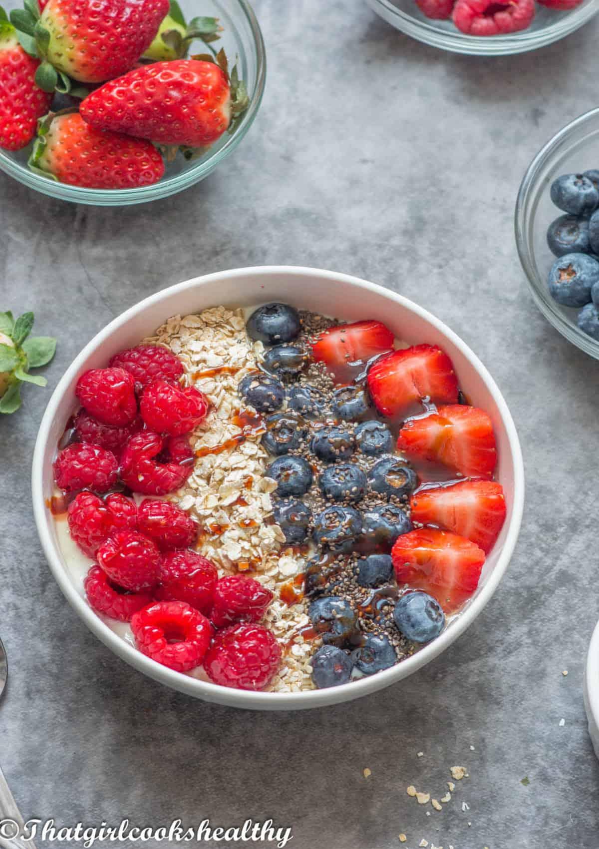 A bowl of homemade coconut yogurt with prunes, garnished with fresh mint