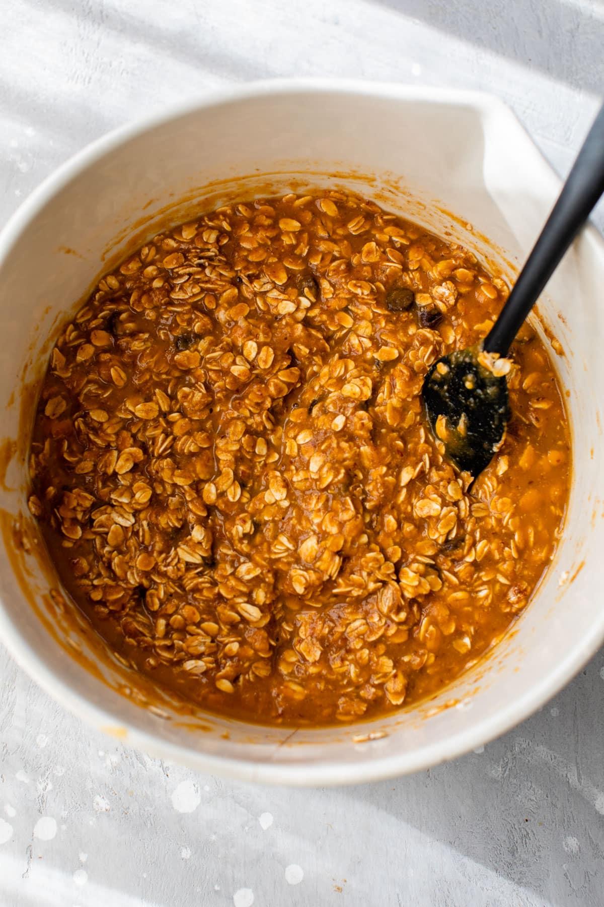 Close-up of a spoonful of pumpkin spice oatmeal being lifted from a bowl