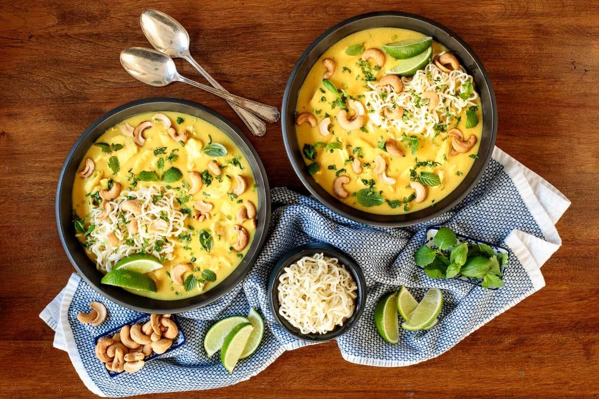 overhead shot of a bowl of steaming coconut curry fried chicken soup