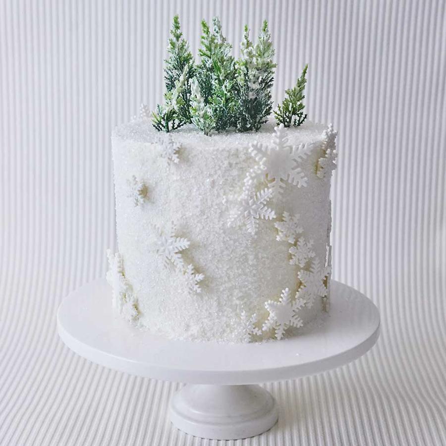 Winter themed birthday cake with snowflakes and edible glitter