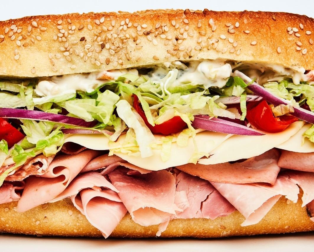 Close-up shot of Italian hoagie wraps with provolone cheese and giardiniera, showcasing the vibrant colors and textures of the ingredients.