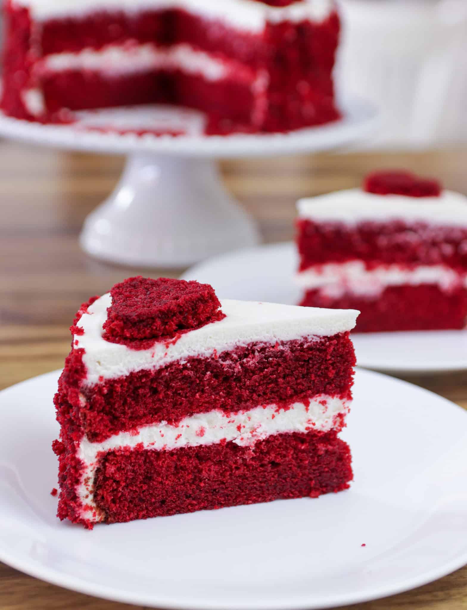 A rich, moist red velvet cake with cream cheese frosting, decorated elegantly.