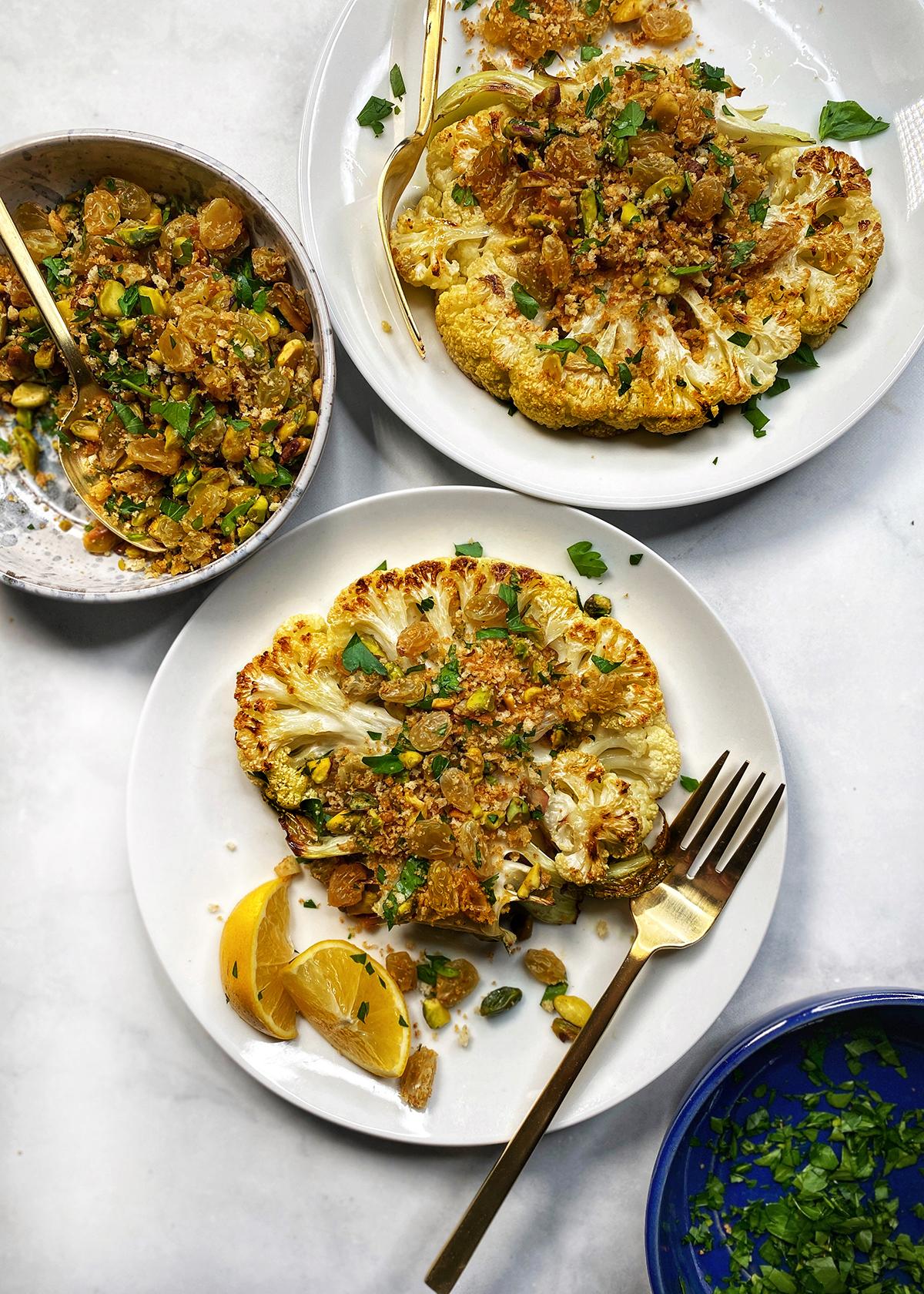 A table set for dinner with the sautéed cauliflower steaks as the centerpiece