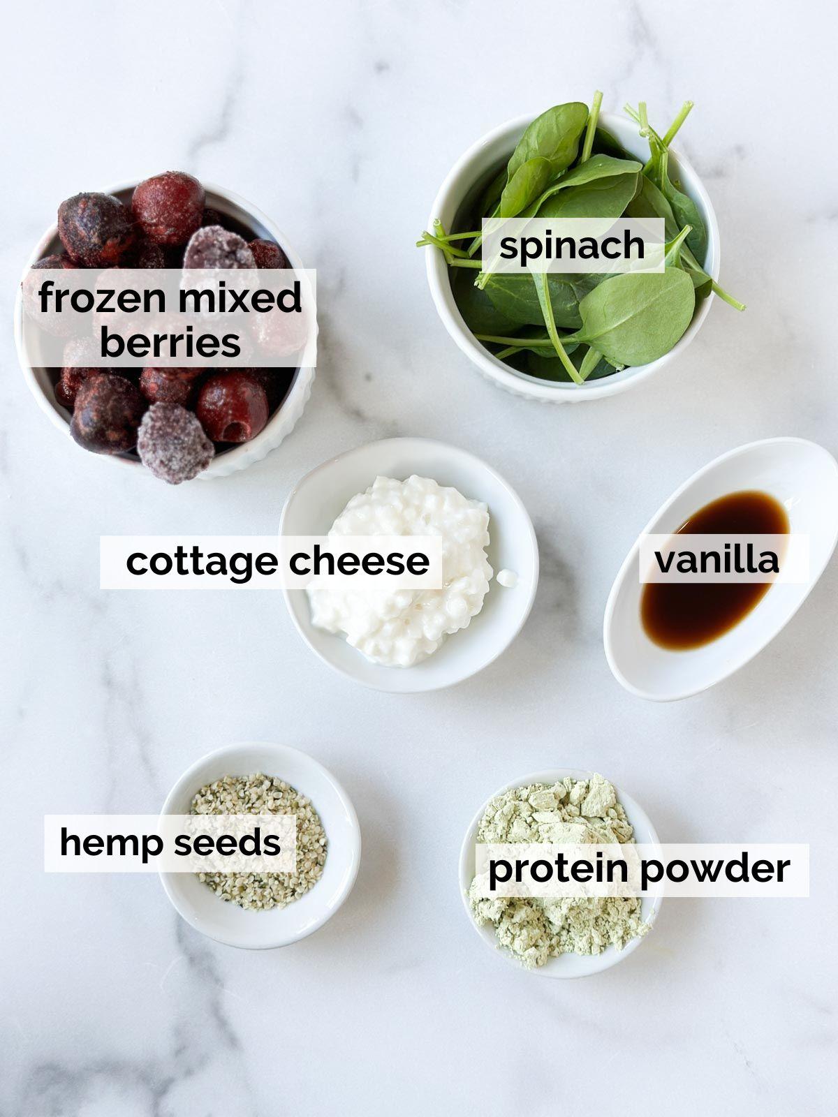 Various ingredients for the mixed berry protein smoothie, neatly arranged