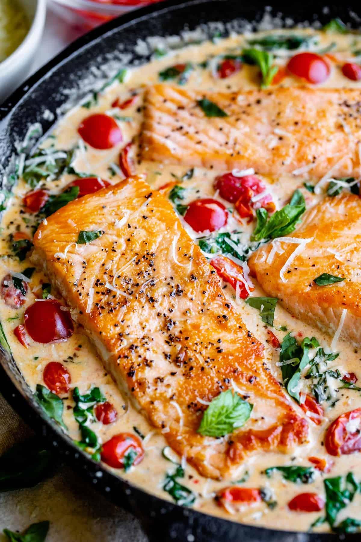 a family enjoying creamy tuscan salmon pasta around a dinner table