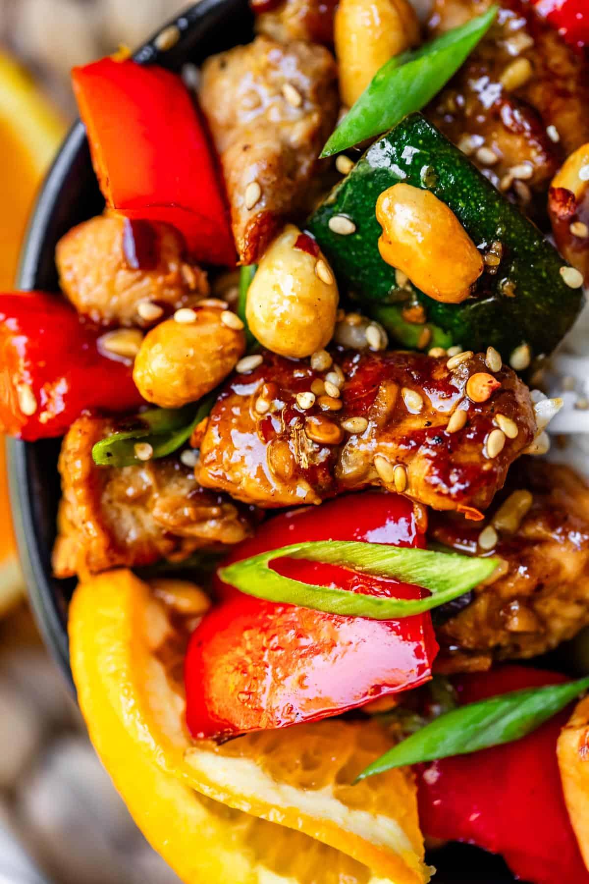 A colorful platter of Kung Pao Stuffed Peppers garnished with green onions and sesame seeds