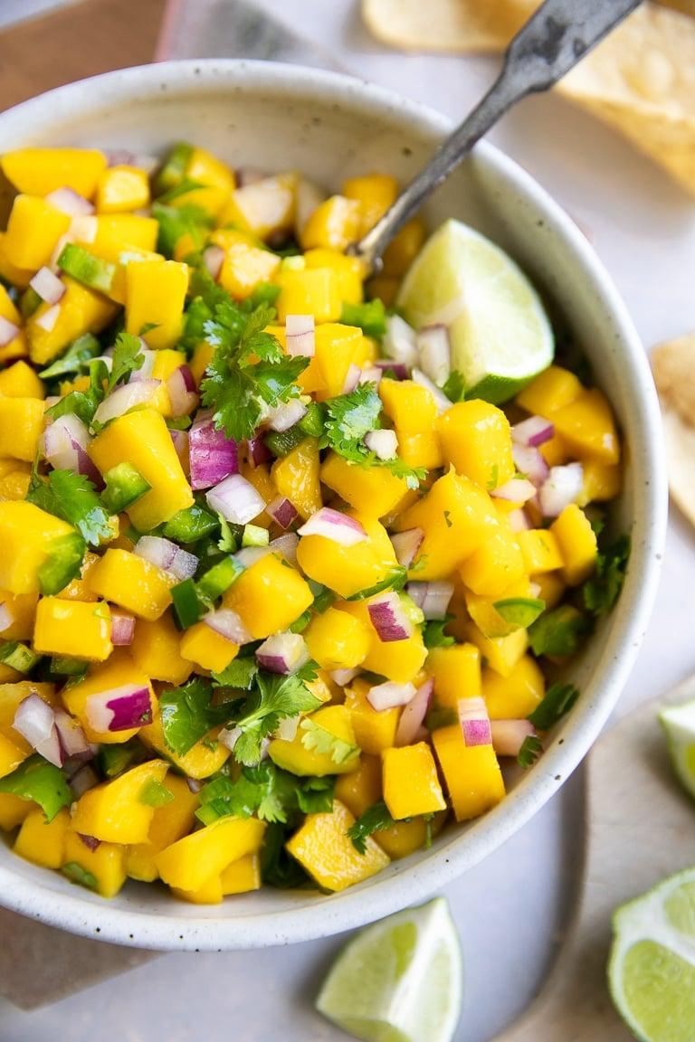 diced mango, red onion, and cilantro in a bowl for making salsa