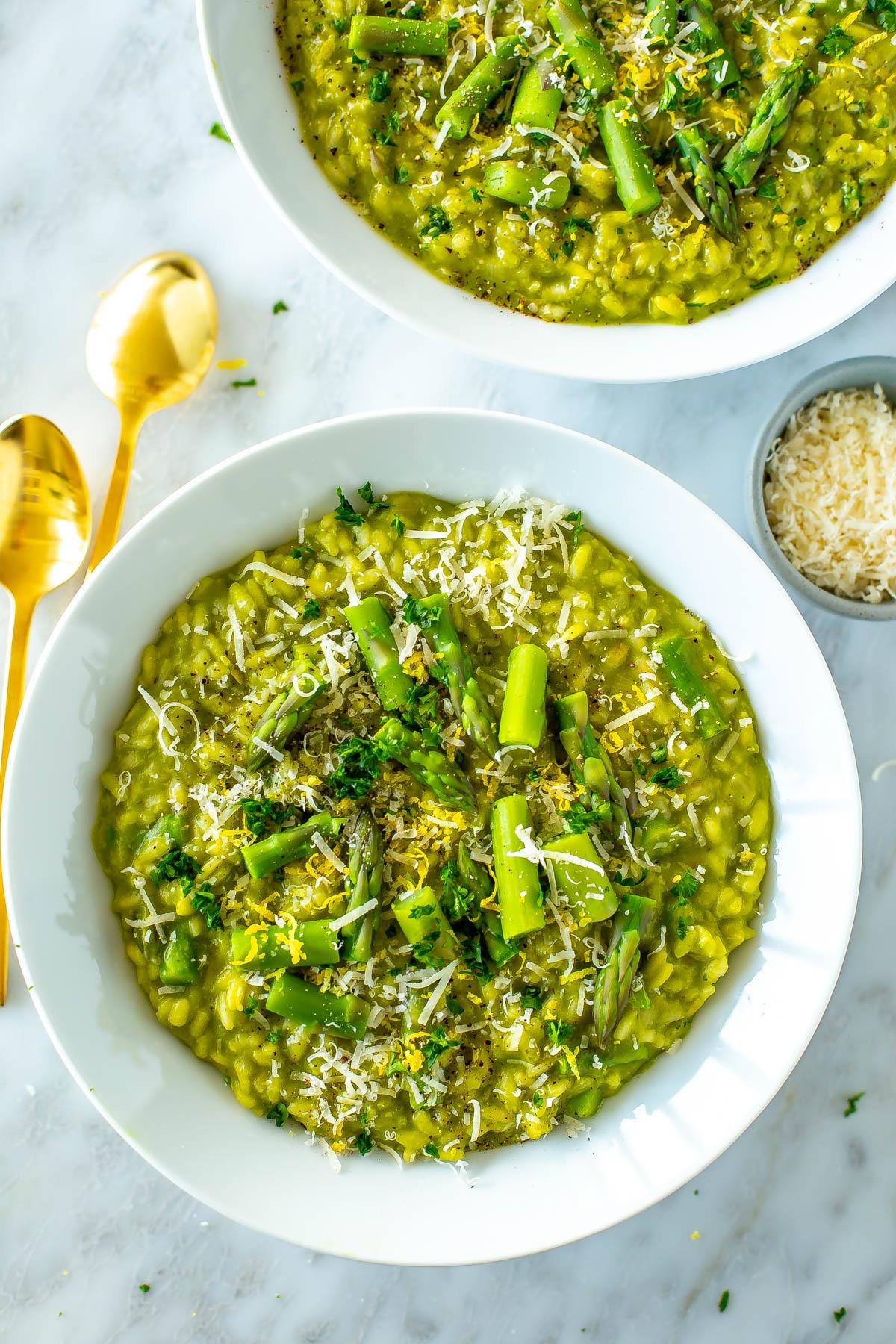 A close-up shot of creamy asparagus risotto with five different types of cheese, garnished with fresh parsley