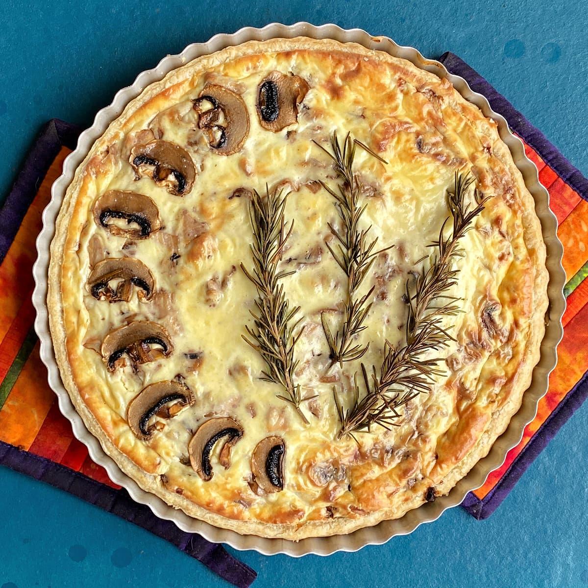 overhead shot of a freshly baked chicken and mushroom quiche