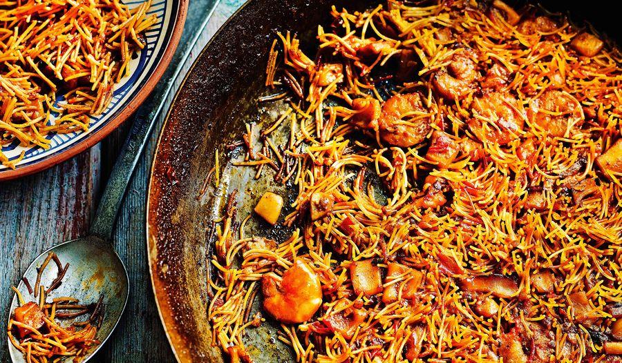 Close-up shot of Paella with Fideuà Noodles, showing the texture of the noodles and toppings
