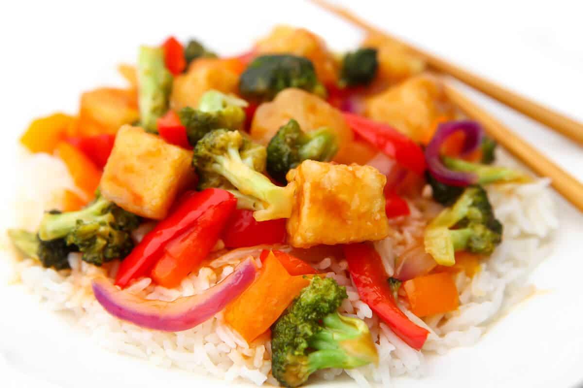 a colorful sweet and sour tofu stir-fry with pineapple, bell peppers, and broccoli