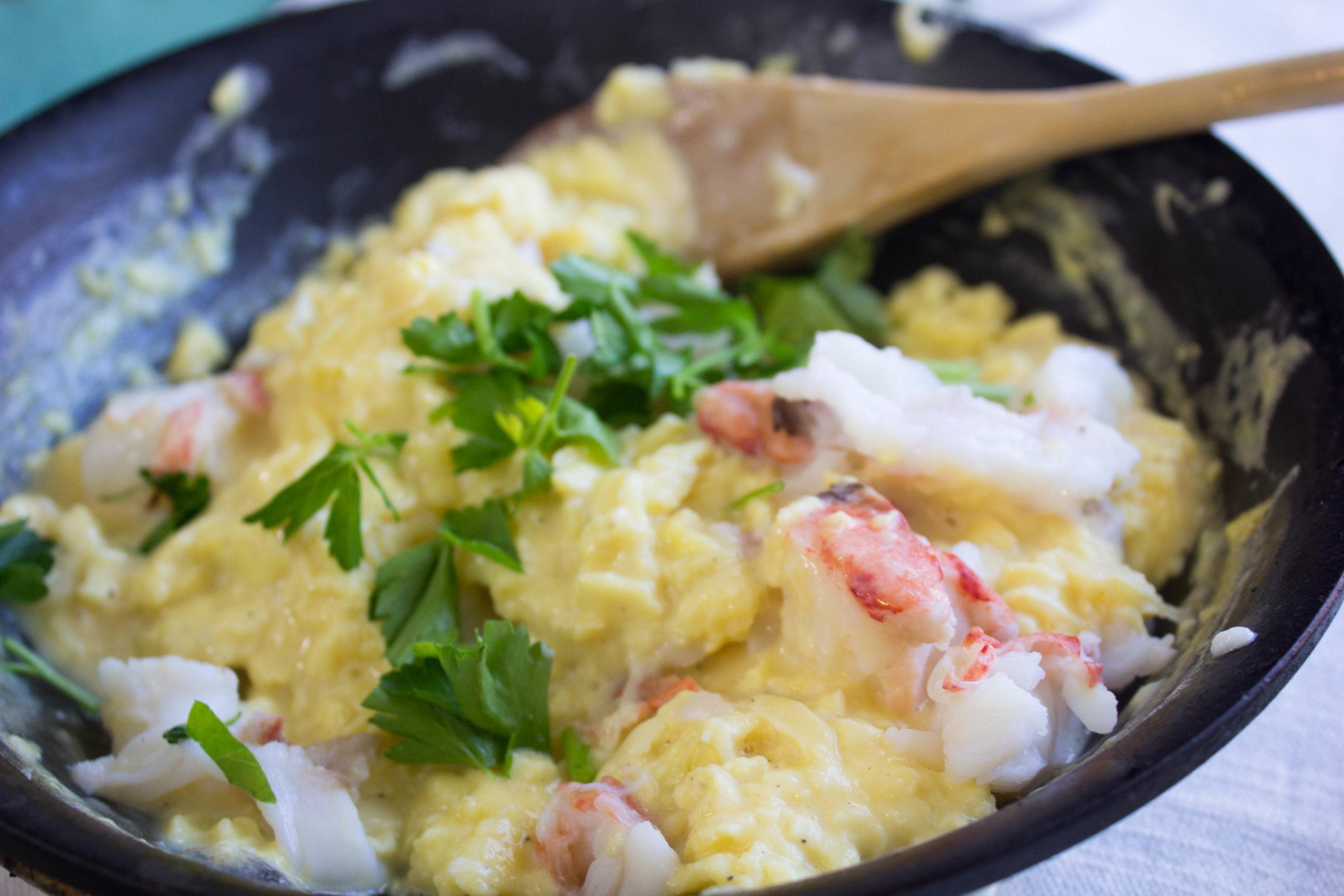 Close-up shot of the ingredients: lobster, Gruyere cheese, eggs, and butter.