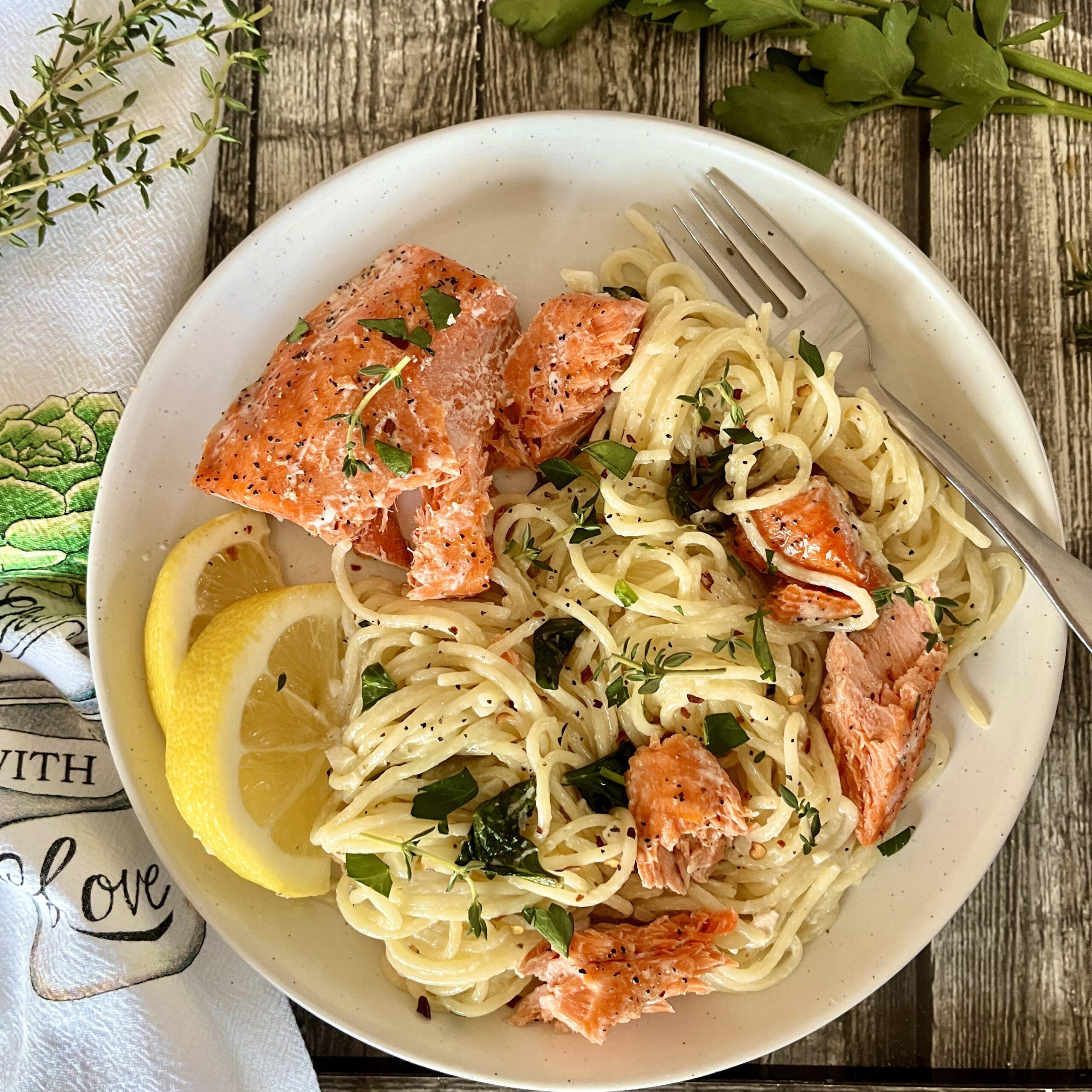 plated pasta dish with salmon gravlax and vibrant lemon butter sauce
