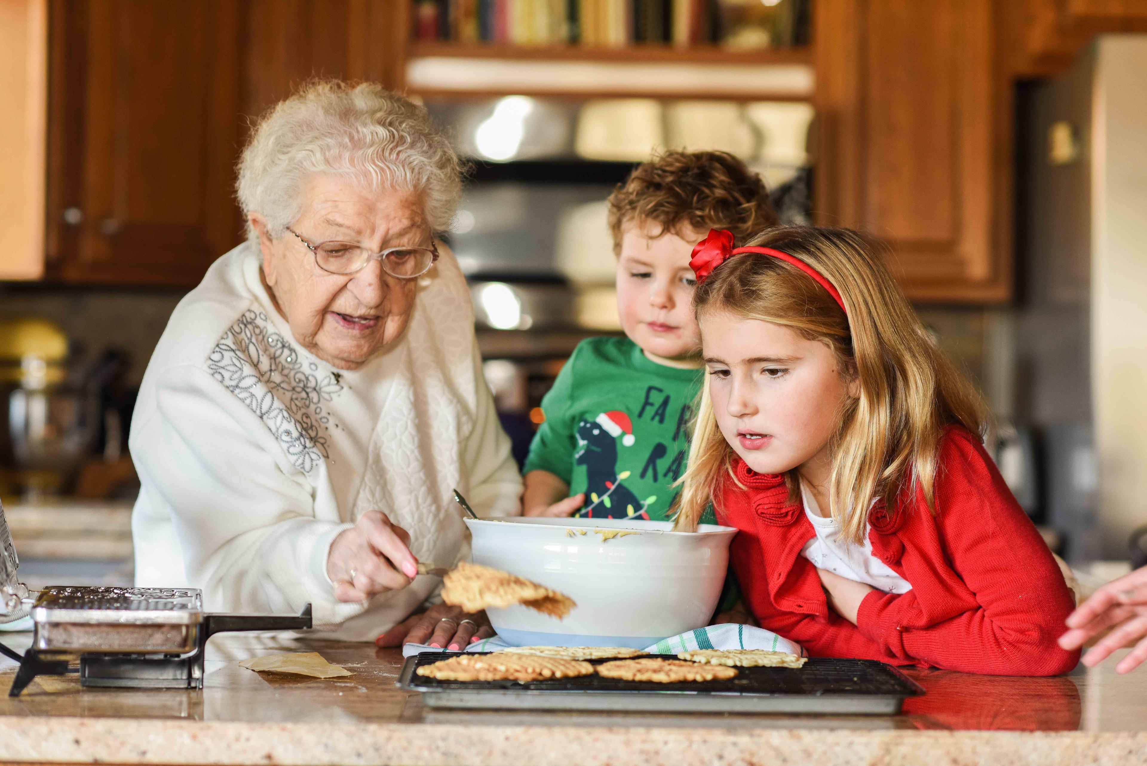 vintage photo of an Italian grandmother making pizzelle cookies in her kitchen