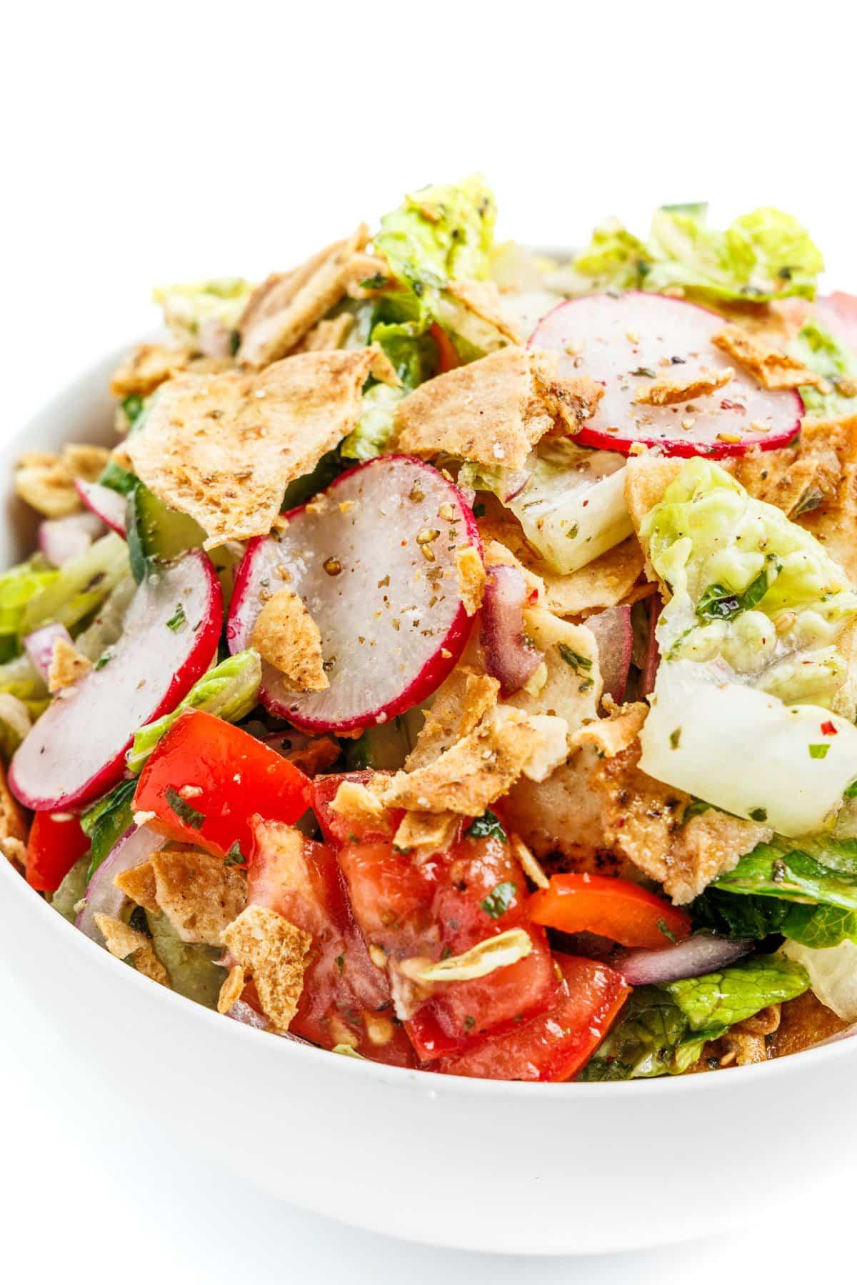 Close-up of a bowl of Fennel and Orange Fattoush with visible toasted pita pieces