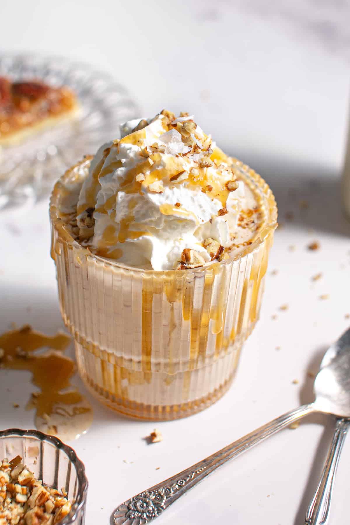 Bowl of pecan pie ice cream being drizzled with caramel