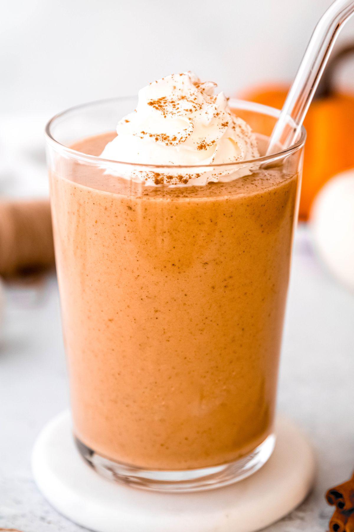 a close-up shot of a rice syrup solids almond power smoothie being poured into a glass