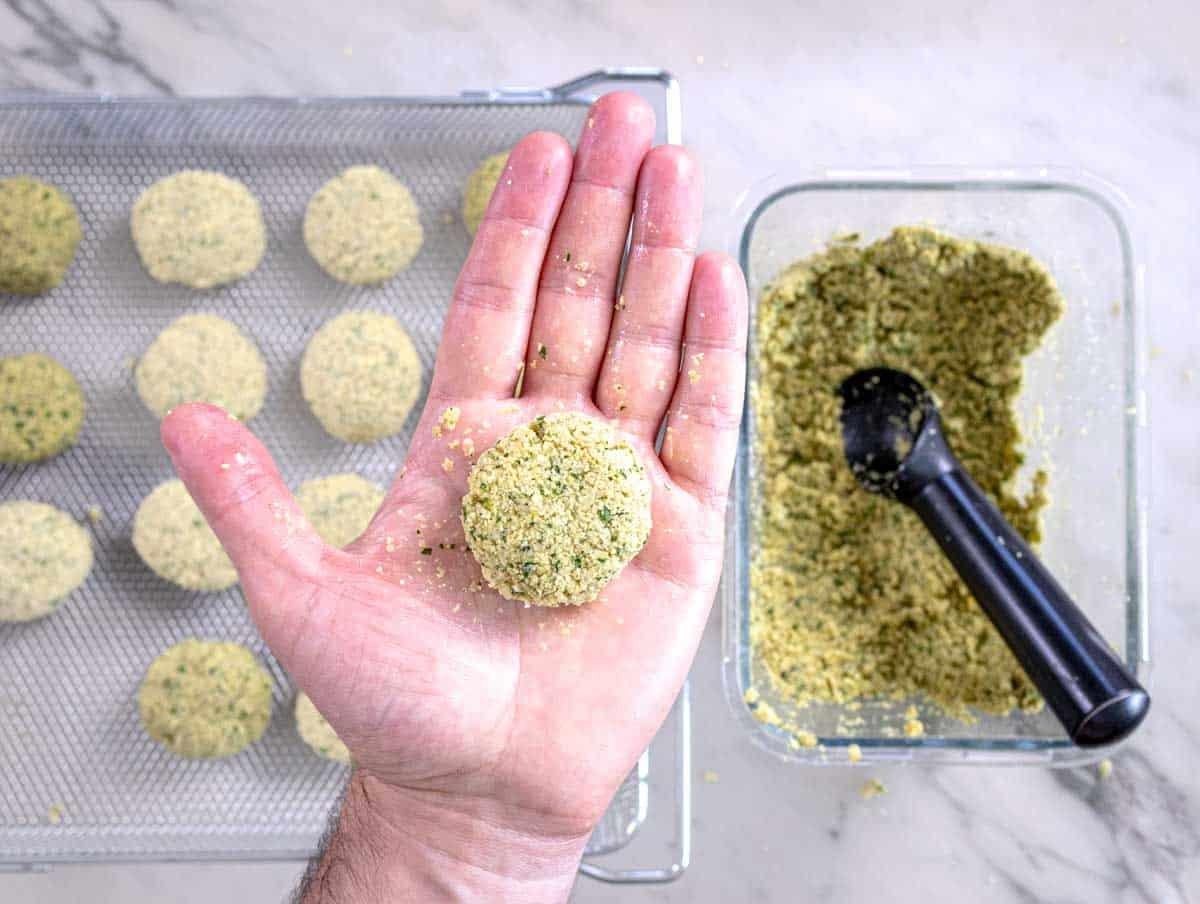 Hands forming falafel balls