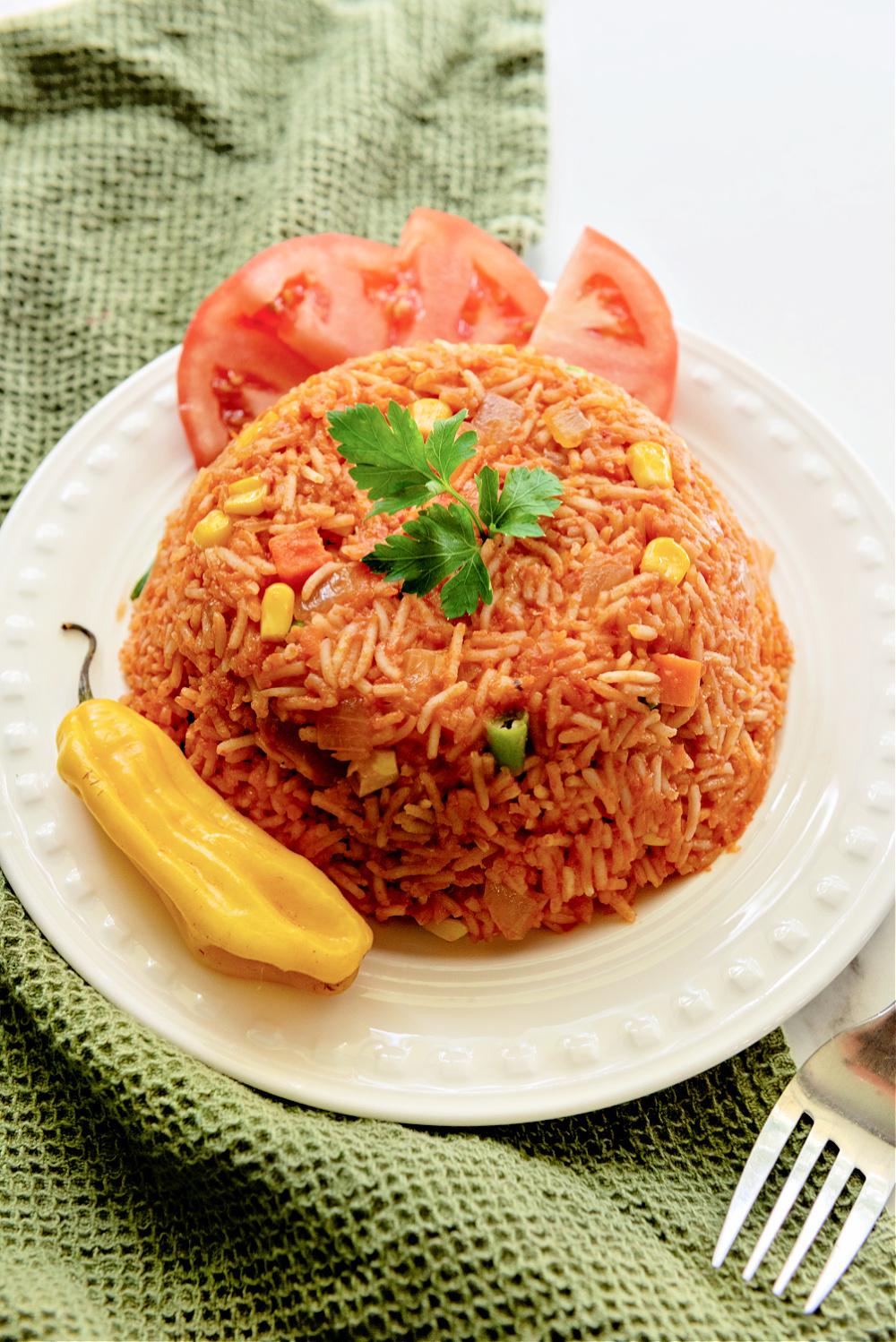 Close-up shot of a bowl of Spicy Jollof Rice with Broccoli & Potatoes, garnished with fresh cilantro.