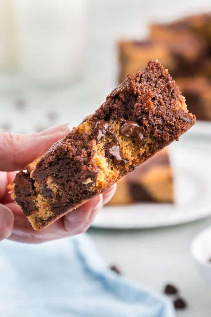 Close up shot of a brownie with cookie dough visible