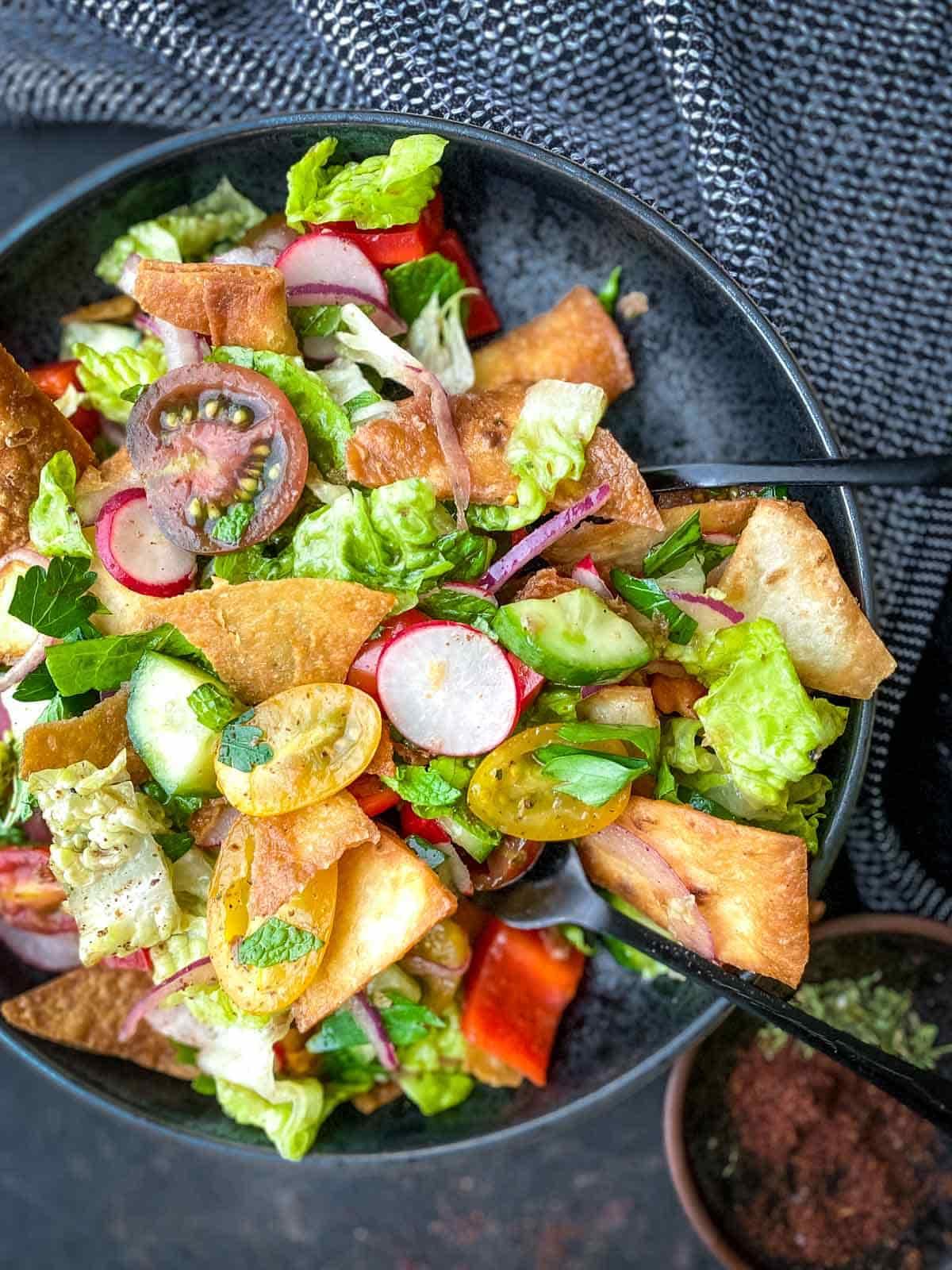 A person enjoying the Fattoush salad outdoors