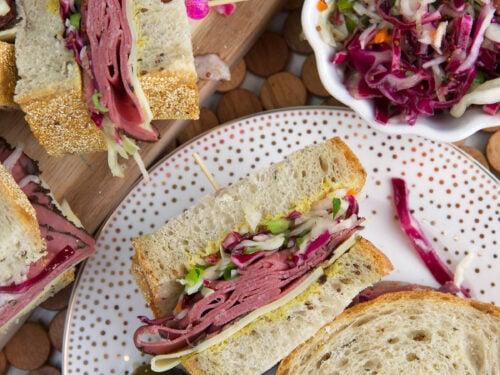 ingredients for pastrami and swiss wrap arranged on a wooden cutting board