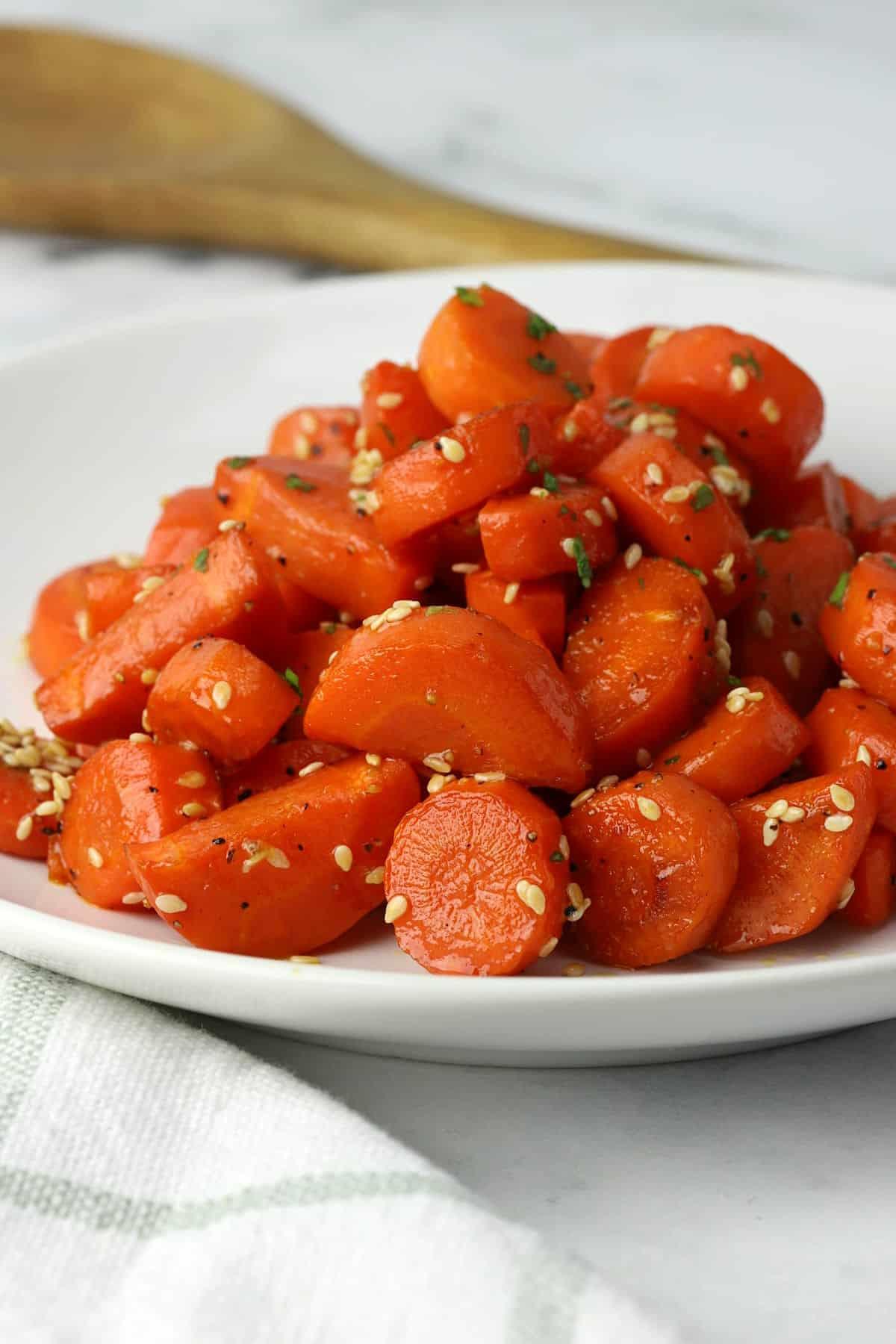close up of honey-glazed carrots grilling with sesame seeds