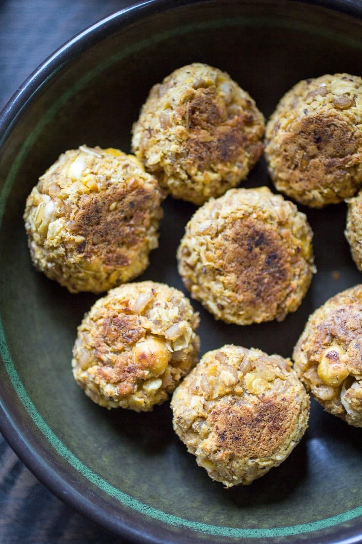 Close-up shot of spicy peanut plant-based meatballs on a baking sheet