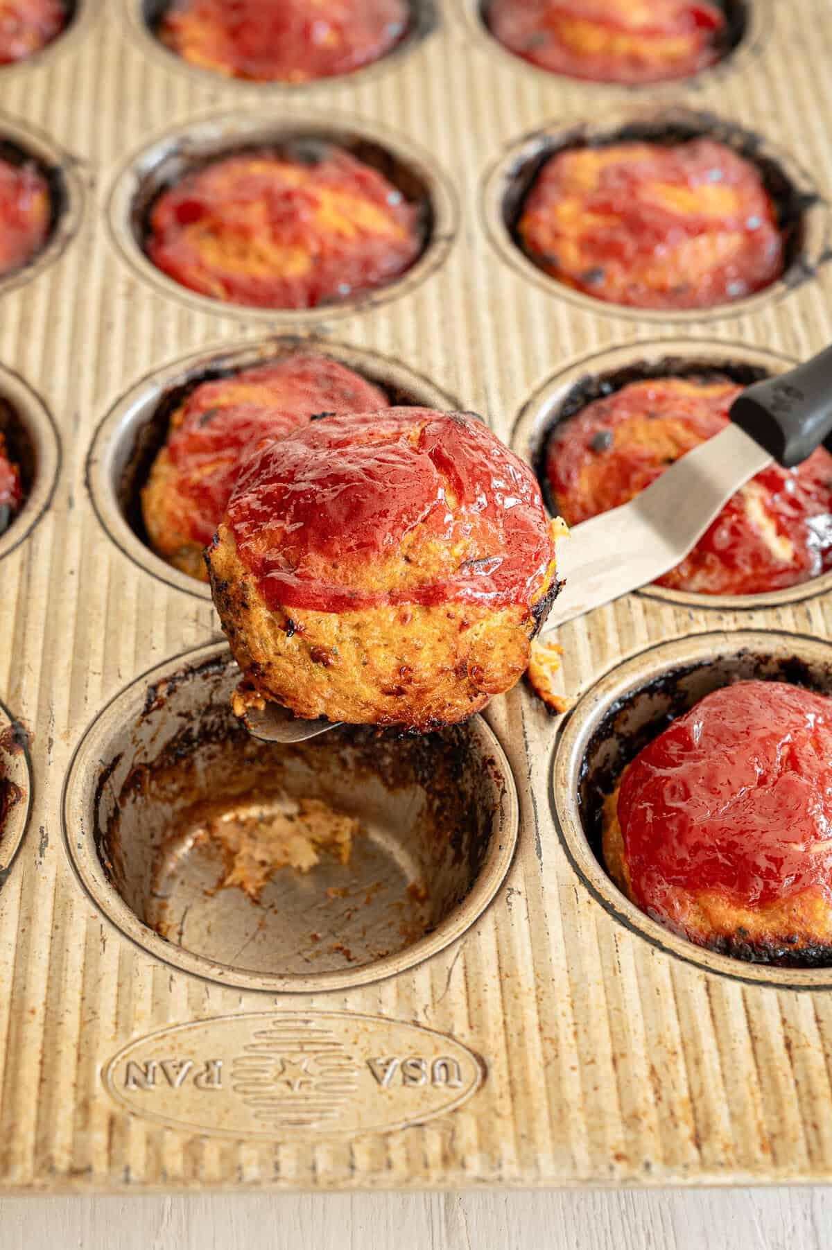A family gathered around a table enjoying turkey meatloaf muffins