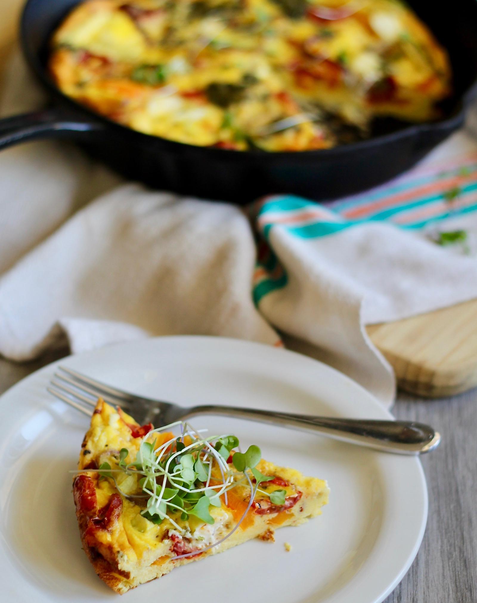 Close-up shot of a slice of creamy pesto frittata