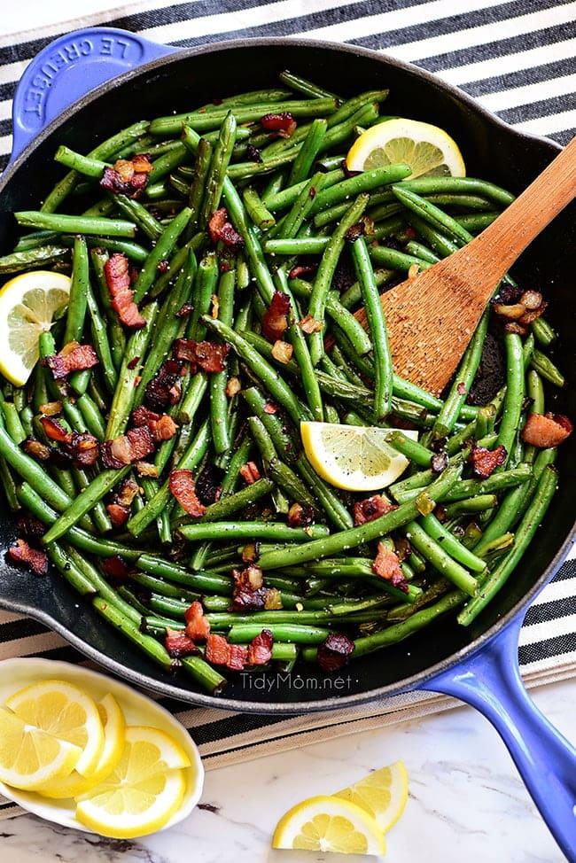 sautéed green beans with bacon on a rustic plate