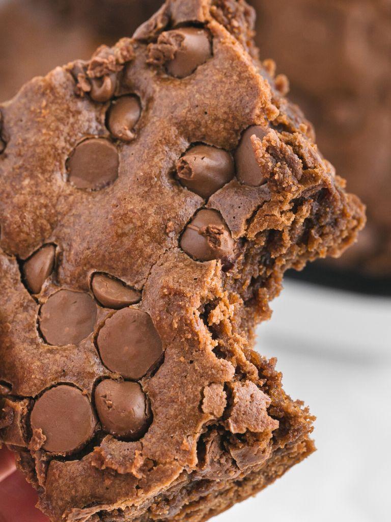 A close-up shot of a brownie, showcasing its creamy texture and rich chocolate color