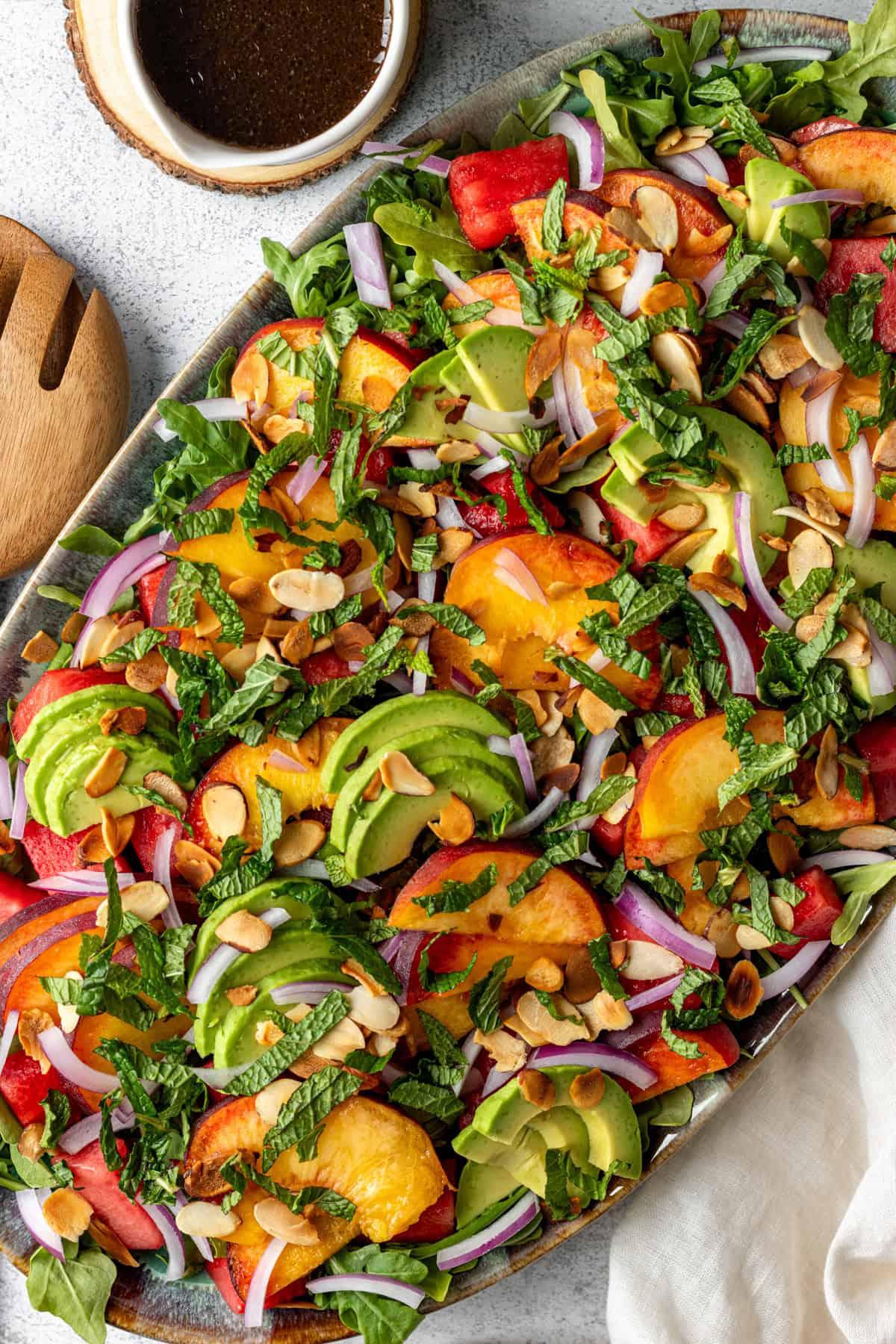 vibrant summer salad with watermelon, peaches, and raspberries