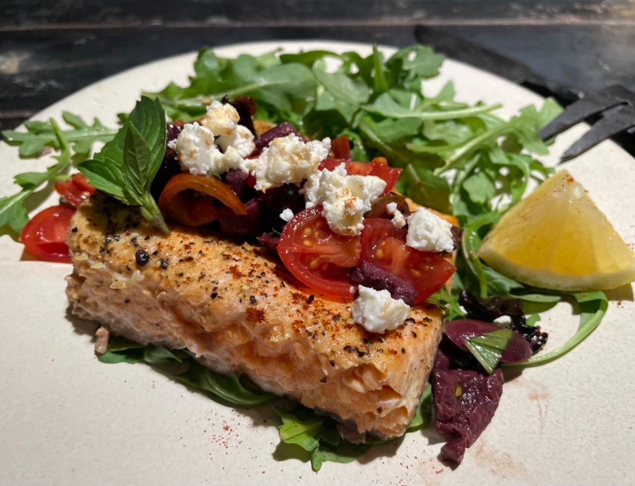 Grilled fish fillets with olives and feta, close-up shot