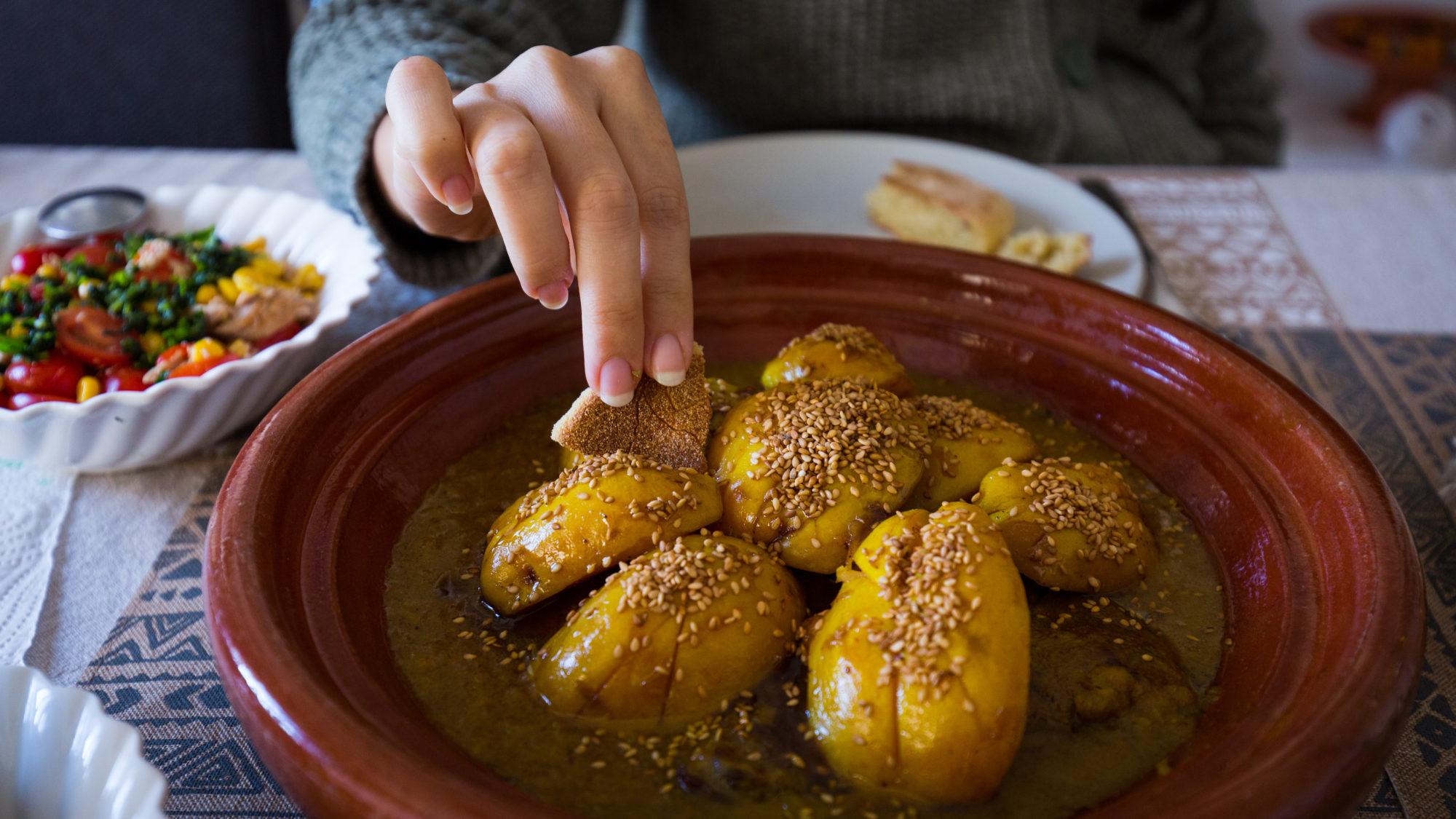 Moroccan tagine with quince and sesame seeds served in a traditional tagine pot