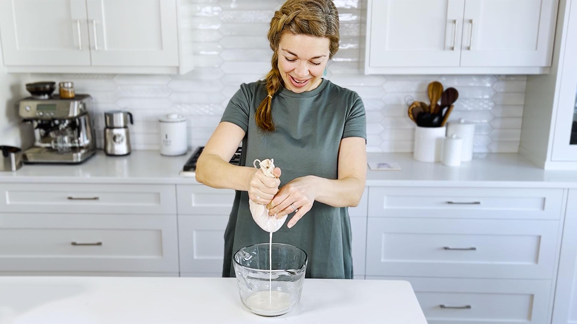 A person happily cooking coconut kötbullar in their kitchen