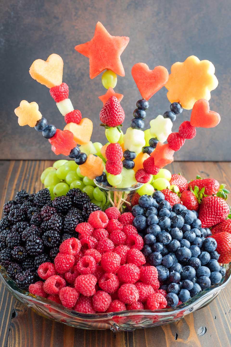 Colorful fruit skewers with various fruits arranged artistically on a platter