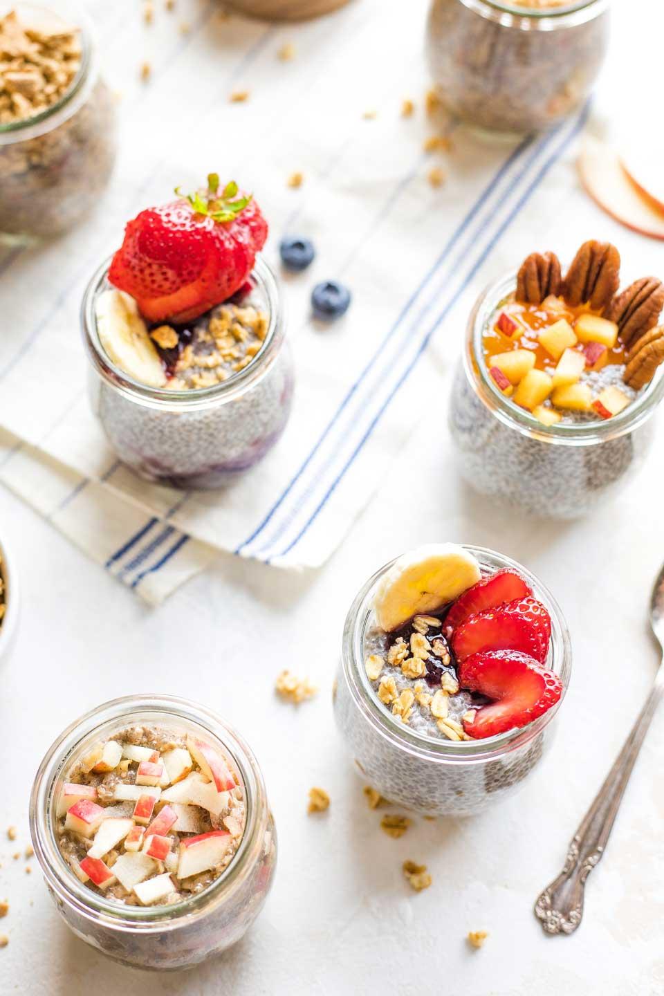 overhead shot of several jars of coconut chia seed pudding with different toppings