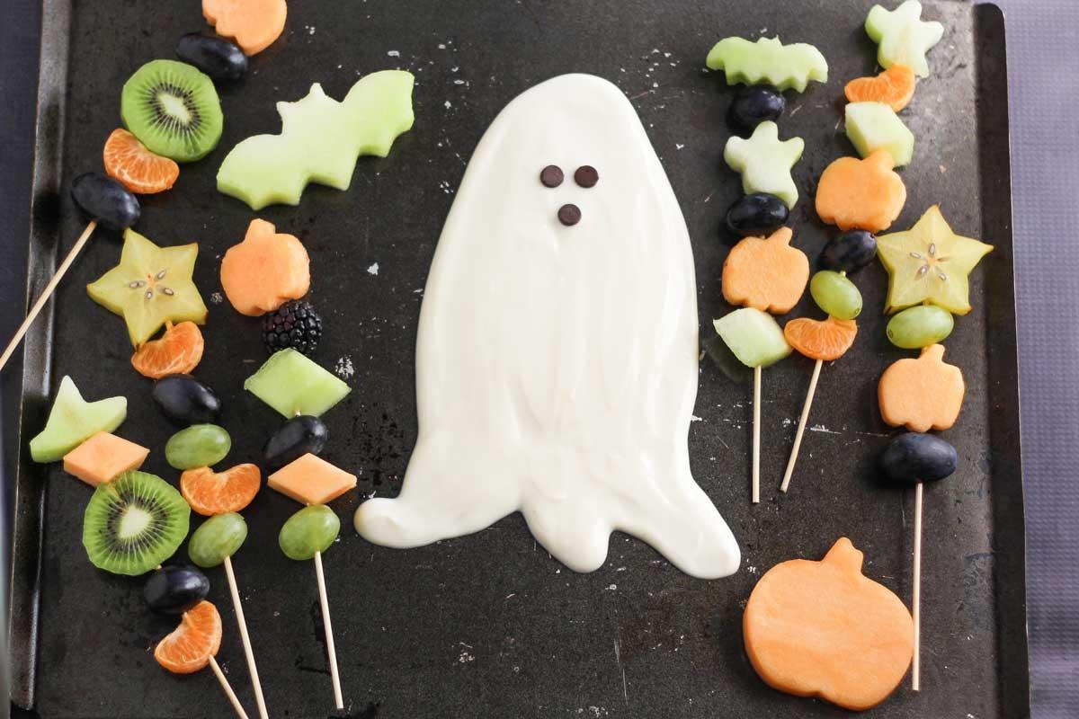 Finished Halloween fruit ghosts arranged on a platter, ready to serve